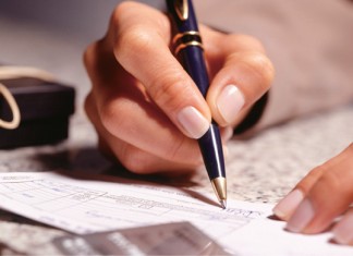Woman_signing_a_cheque