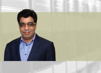 A photo of Deepak Sabharwal on an article about commercial courts act